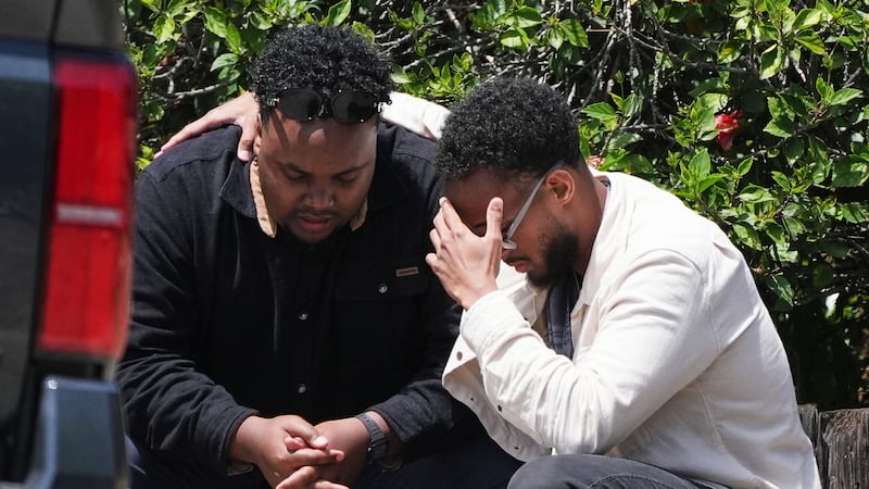 Two men embrace at the scene of a shooting outside the Islamic Center of San Diego Monday, May...
