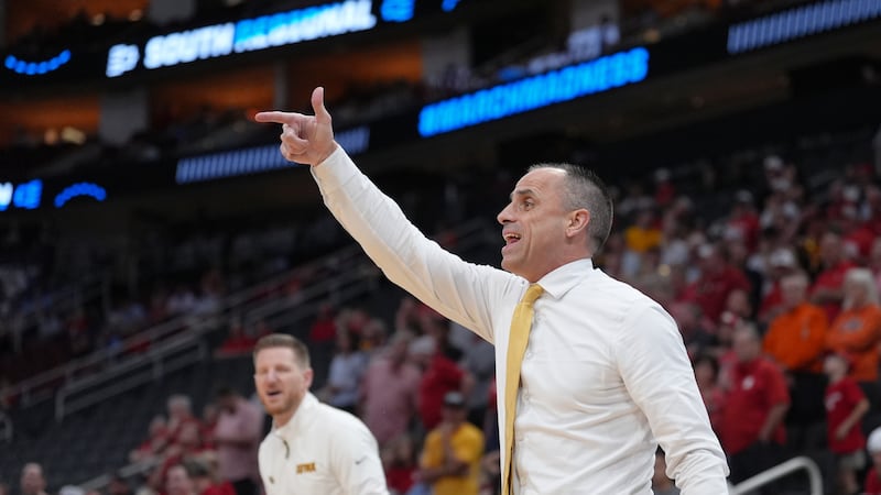 Iowa head coach Ben McCollum directs his players during the first half against Nebraska in the...