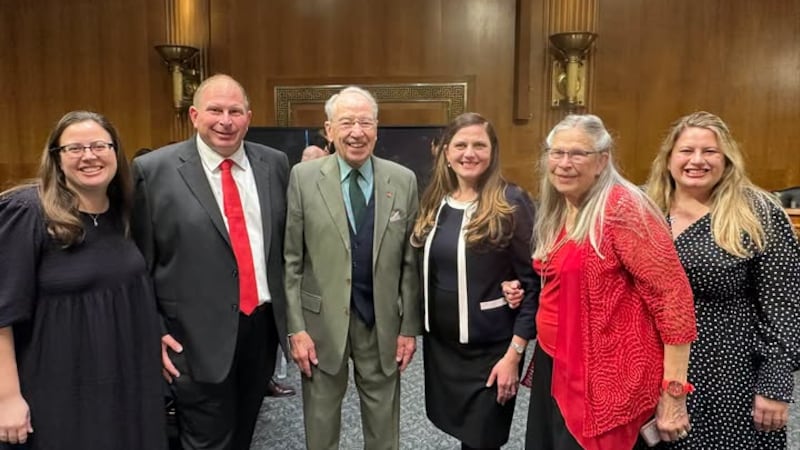 Senator Chuck Grassley (third from left) poses with Kara Westercamp (fourth from left) at her...